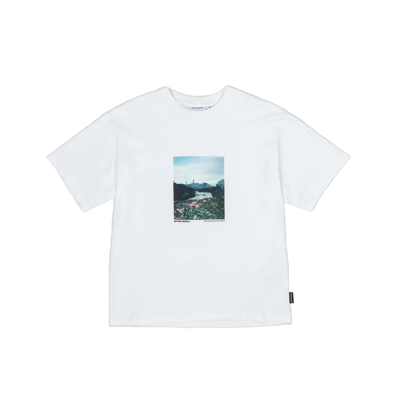 White t-shirt with a small graphic on a gray background