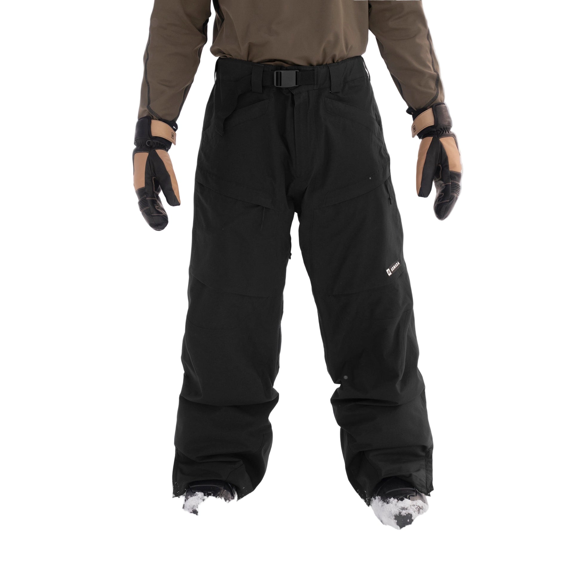 Person wearing black snow pants and brown jacket in a snowy landscape