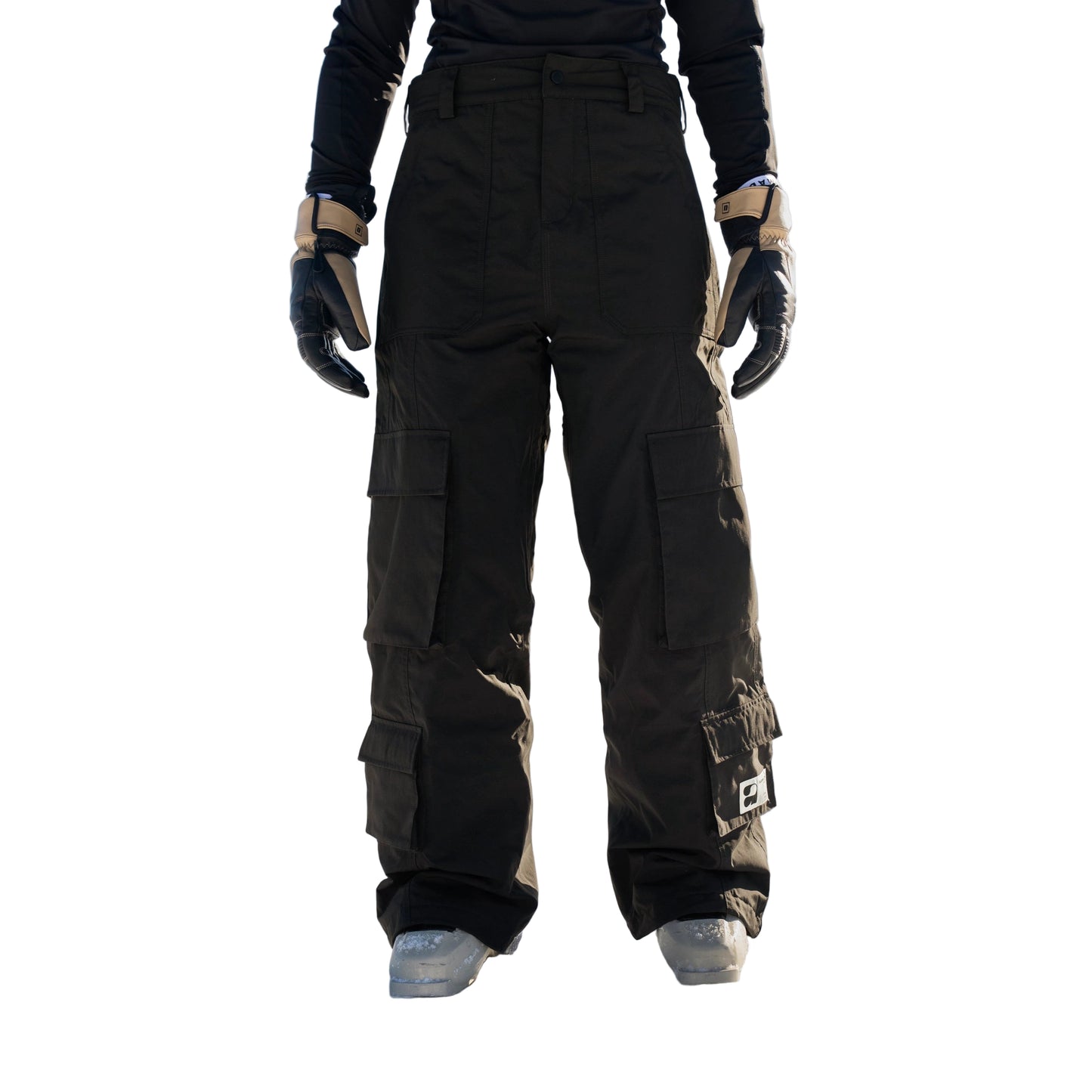 Person wearing black snow pants standing in a snowy landscape