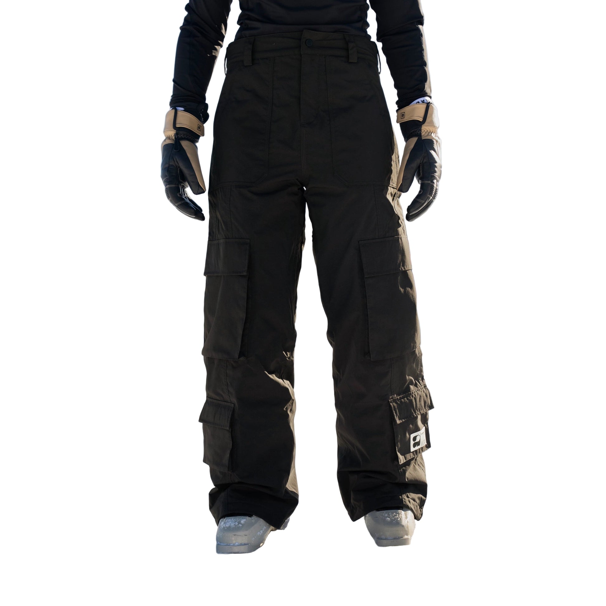 Person wearing black snow pants standing in a snowy landscape