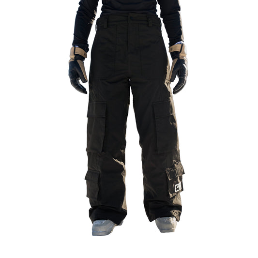 Person wearing black snow pants standing in a snowy landscape