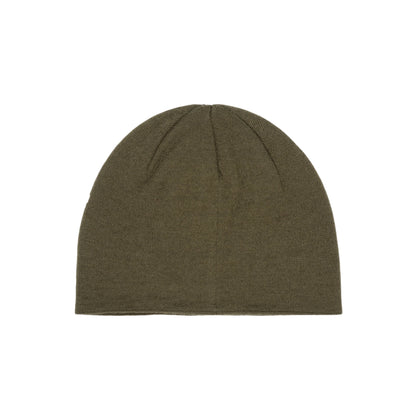 Green beanie on a textured white background
